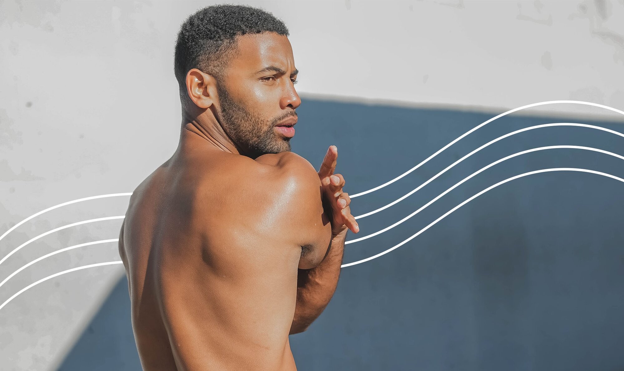 Shirtless black man stretching outside who's feeling confident because he just got neck laser hair removal